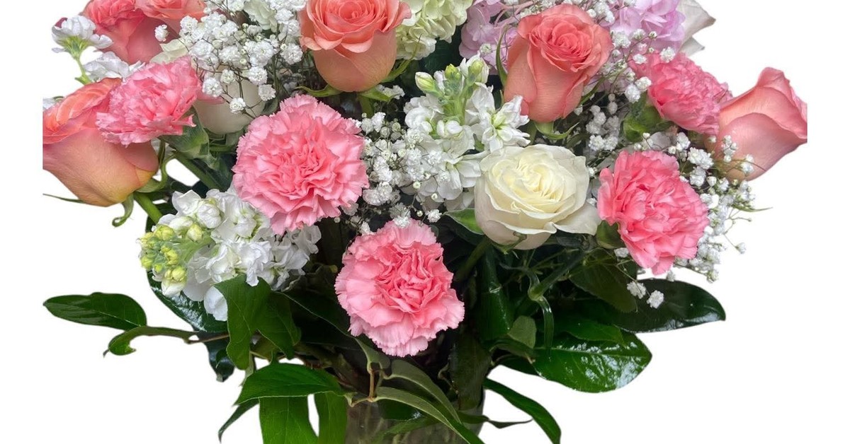 Fresh pink roses, white flowers and carnations arranged as a bouquet