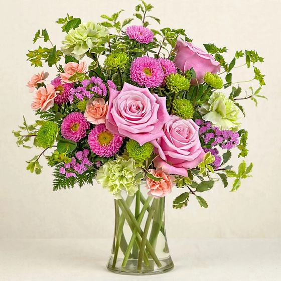 Blush Garden Bouquet with pink roses, pink and green mums, and peach carnations on a cream background