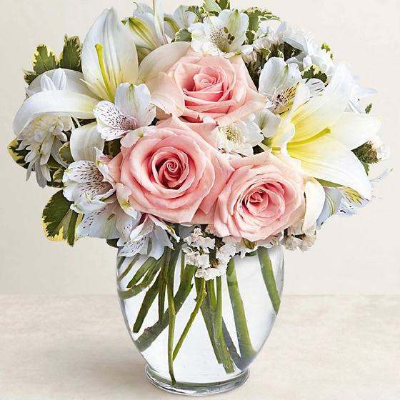 Blush Lily Charm Bouquet with blush roses, white lilies and white alstroemeria on a cream background
