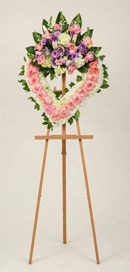 Blush Pink Heart Wreath of pink roses with a white floral border on a cream background