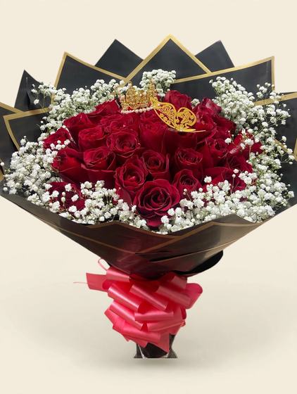 Fifty red roses with a golden crown, golden butterfly, black and gold wrap, and a red bow