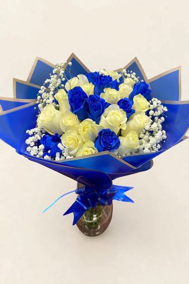 Fifty white and blue roses in royal blue and gold wrap with a blue bow