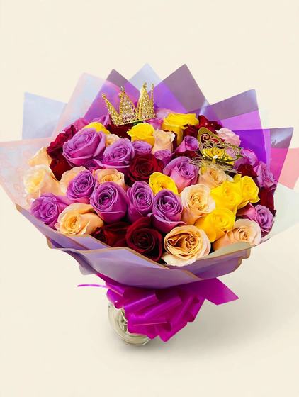 Fifty purple, yellow, red and peach roses with a golden crown, butterfly, purple wrap, and a fuchsia bow