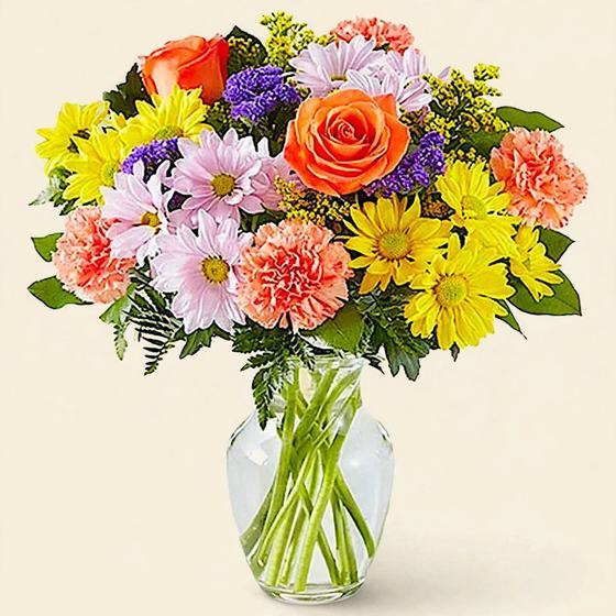 Citrus Garden Bouquet with orange roses, yellow daisies and coral carnations on a cream background