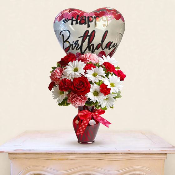Red roses, white daisies and carnations in a red vase with a Happy Birthday balloon