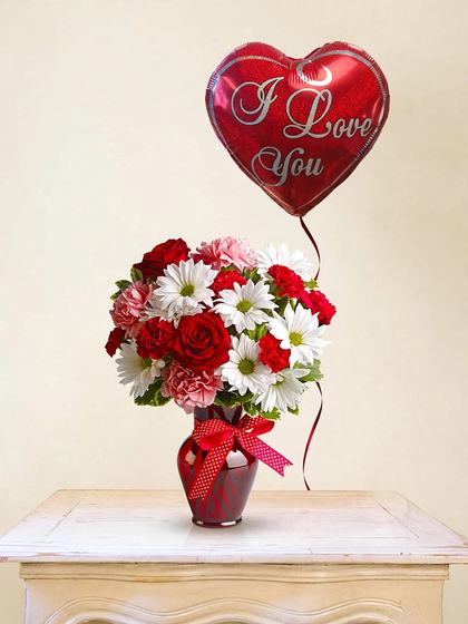 Red roses, white daisies and carnations in a red vase with an I Love You heart balloon