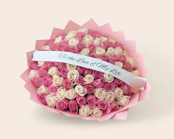 Fifty pink and white roses in pink wrap with a To the Love of My Life ribbon