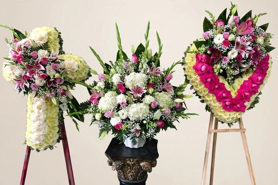 Divine Love Funeral Set with a white and pink cross, a white and pink urn arrangement, and a pink heart wreath