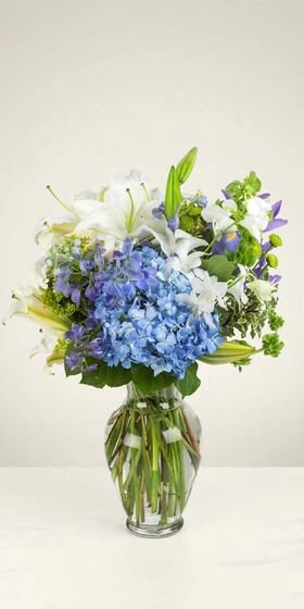 Heavenly Blue Bouquet with blue hydrangea and white lilies on a cream background