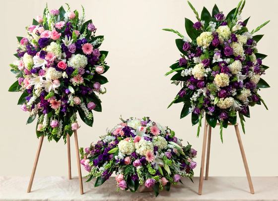 Lavender Peace Funeral Set with two standing sprays and a casket spray in lavender, purple, white and pink