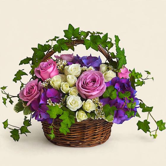 Lavender and White Sympathy Basket with lavender roses, white roses, purple hydrangea and ivy on a cream background