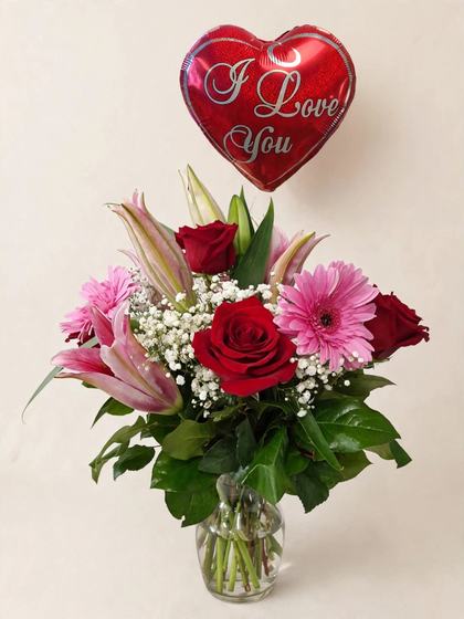 Red roses, pink lilies and gerberas with baby's breath and an I Love You heart balloon