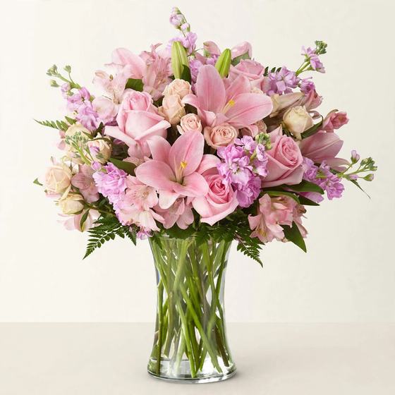 Pink Lily Dreams Bouquet with pink lilies, pink roses and lavender blooms on a cream background