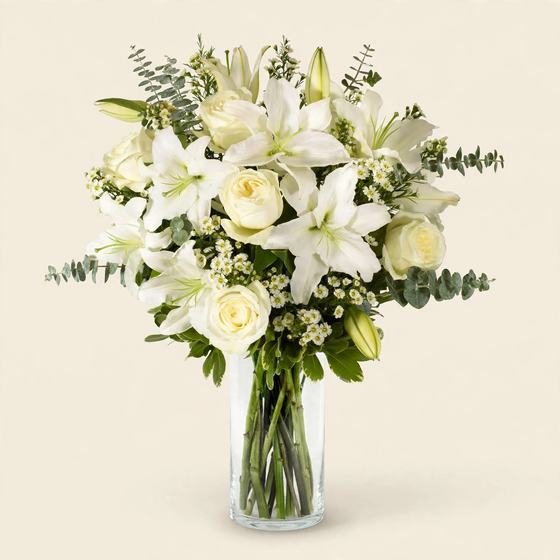 Pure Grace Bouquet with white lilies, white roses and eucalyptus on a cream background