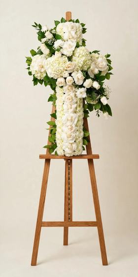 Pure White Cross with white roses and white hydrangea displayed on a tall wooden easel
