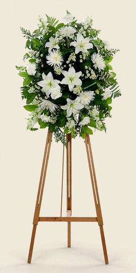 Pure White Standing Spray with white lilies, white chrysanthemums and white carnations on a tall wooden easel