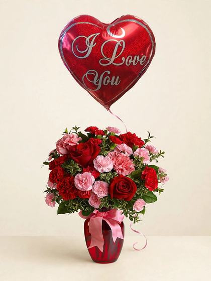 Red roses and pink and red carnations in a red vase with an I Love You heart balloon